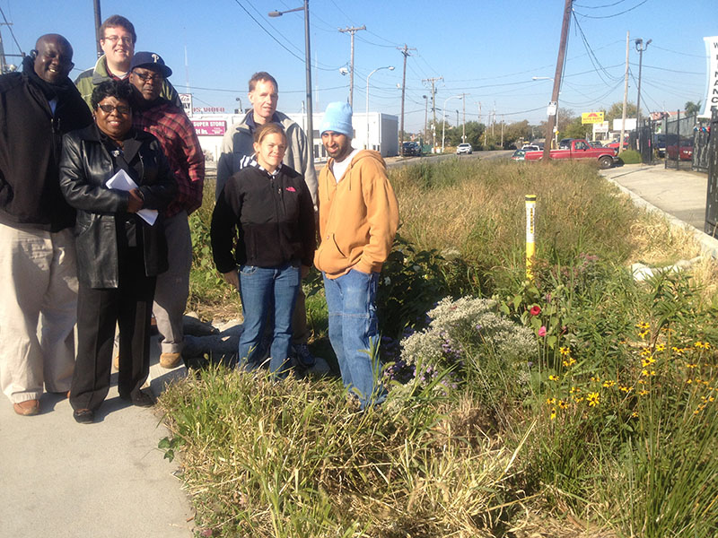 photo of a group from Southwest Community Development Corporation standing by one of the rain gardens they help maintain