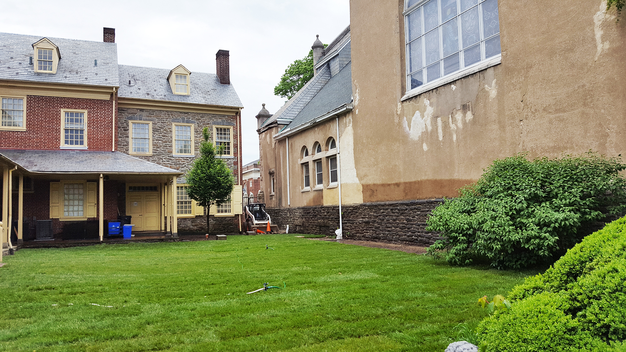 a grassy courtyard surrounded by 18th century buildings