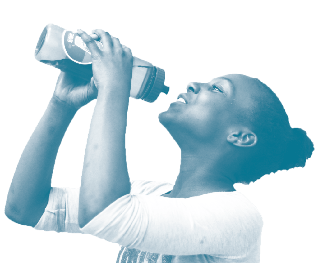 A young smiling girl holds a reusable water bottle and gets ready to take a drink. She has darker skin and dark curly hair.