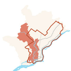 a minimalist map showing Philadelphia outlined in orange, and the Schuylkill River Watershed shaded in orange, stretching north and south through much of the western side of the city.