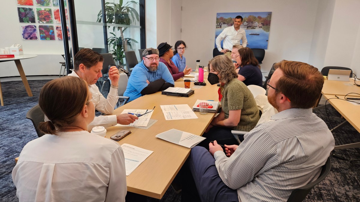 A group of employees sitting around a conference table discussing the Strategic Plan