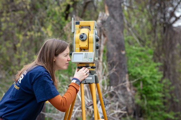 PWD employee surveying land as part of Ecological Restoration work.