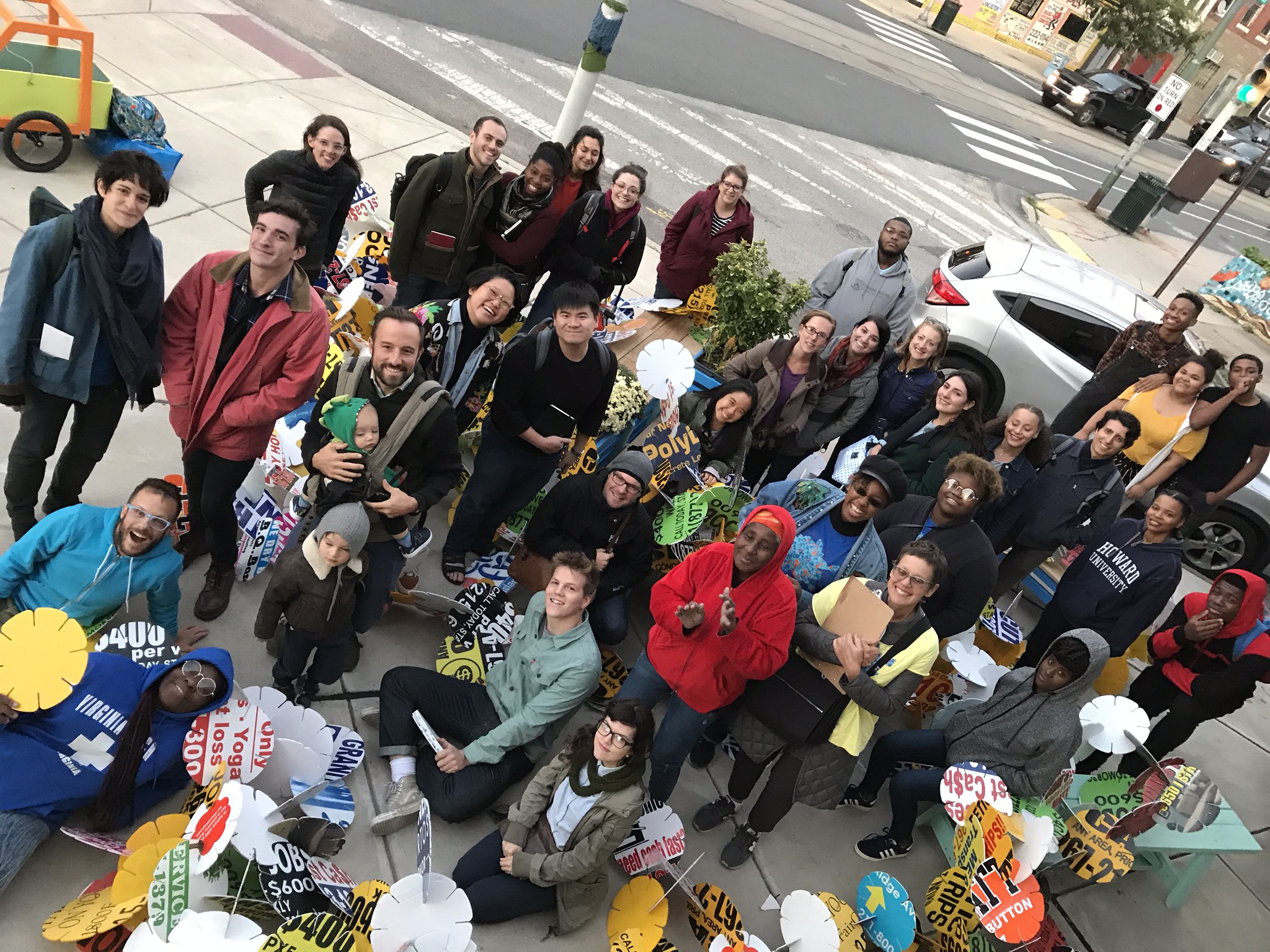 the crowd at a Tiny-WPA-hosted community event at the 16th District station smiles for a photo taken from above at a crazy angle